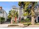 Gray two-story home with red door, brick walkway, and lush landscaping at 70 Warren St, Charleston, SC 29403