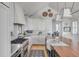 Open concept kitchen with white cabinets, gas range, and large island at 70 Warren St, Charleston, SC 29403