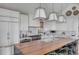 Modern kitchen, featuring white cabinets and a wood island at 70 Warren St, Charleston, SC 29403