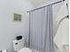 Simple bathroom with shower/tub, white toilet and gray striped shower curtain at 1025 Riverland Woods Pl # 208, Charleston, SC 29412