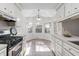 White kitchen cabinets, tile floor, and breakfast nook at 1045 Shinnecock Hills Ct, Summerville, SC 29483