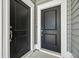 Two black front doors with brass hardware at 107 Cotton Blossom Way, Summerville, SC 29485