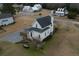 White farmhouse with gray roof, screened porch, and private backyard at 1104 Hitchfield Ln, Awendaw, SC 29429