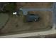 White farmhouse with gray roof and private driveway; pond and outbuildings visible at 1104 Hitchfield Ln, Awendaw, SC 29429