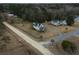White farmhouse on a quiet street with other homes nearby at 1104 Hitchfield Ln, Awendaw, SC 29429