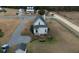 White farmhouse with gray roof, screened porch, and private backyard with patio at 1104 Hitchfield Ln, Awendaw, SC 29429