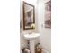 Elegant bathroom with pedestal sink and decorative mirror at 1104 Hitchfield Ln, Awendaw, SC 29429