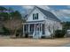 Charming one-story home with a wrap-around porch and landscaped yard at 1104 Hitchfield Ln, Awendaw, SC 29429