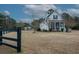 White house with black fence and spacious yard at 1104 Hitchfield Ln, Awendaw, SC 29429
