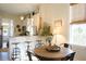 Bright kitchen with island, breakfast bar, and adjacent dining area at 1104 Hitchfield Ln, Awendaw, SC 29429