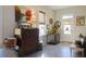Living room features antique dresser, dog crate, and hardwood floors at 1104 Hitchfield Ln, Awendaw, SC 29429