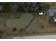 Heart-shaped pond next to a white farmhouse and a wooded area at 1104 Hitchfield Ln, Awendaw, SC 29429