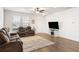 Living room features hardwood floors, a brown leather sectional sofa, and a fireplace at 1148 Flyway Rd, Summerville, SC 29483