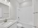 A bright bathroom with white subway tile around the tub and a single sink vanity at 1149 Reserve Ln, Awendaw, SC 29429