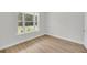 Empty bedroom with hardwood floors and a large window at 1149 Reserve Ln, Awendaw, SC 29429