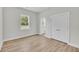 A bedroom offers hardwood floors, natural light from the windows, and closet space at 1149 Reserve Ln, Awendaw, SC 29429