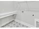 A laundry room offers gray patterned floors and a white quartz folding countertop space at 1149 Reserve Ln, Awendaw, SC 29429