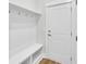 A mudroom provides built-in bench with storage and coat hooks by the front door entrance at 1149 Reserve Ln, Awendaw, SC 29429