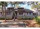 Two-story townhome with gray siding, fenced yard, and mature trees at 1240 Creek Watch Trce, Seabrook Island, SC 29455