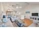 Open-concept living room with hardwood floors, vaulted ceiling, and access to screened porch at 1240 Creek Watch Trce, Seabrook Island, SC 29455