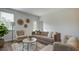 Living room with a brown sofa, armchairs, coffee table, and large windows at 135 River Hill Rd, Goose Creek, SC 29445