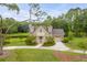 Stunning home with a manicured lawn and a circular driveway at 1484 Old Rosebud Trl, Awendaw, SC 29429