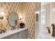 Stylish bathroom with patterned wallpaper and a modern vanity at 1484 Old Rosebud Trl, Awendaw, SC 29429