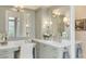 Elegant bathroom with a double vanity and a large mirror at 1484 Old Rosebud Trl, Awendaw, SC 29429