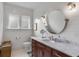 Elegant bathroom with marble vanity, hexagon tile floor, and a large round mirror at 1484 Old Rosebud Trl, Awendaw, SC 29429