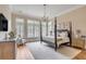 Main bedroom with a four-poster bed and large windows at 1484 Old Rosebud Trl, Awendaw, SC 29429
