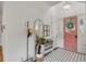 Inviting entryway with a coral door and black and white tile floor at 1484 Old Rosebud Trl, Awendaw, SC 29429