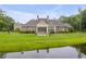 Stone house with patio, pond, and large backyard at 1484 Old Rosebud Trl, Awendaw, SC 29429