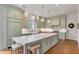 Spacious kitchen with light green cabinets, white countertops, and a large island at 1484 Old Rosebud Trl, Awendaw, SC 29429
