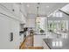 Bright kitchen boasts white cabinets, high-end appliances, and spacious layout at 1484 Old Rosebud Trl, Awendaw, SC 29429