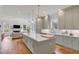 Open concept kitchen with island, white countertops and green cabinets at 1484 Old Rosebud Trl, Awendaw, SC 29429