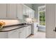 Convenient laundry room with white cabinets and a large window at 1484 Old Rosebud Trl, Awendaw, SC 29429