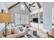 Cozy living room featuring a vaulted ceiling, built-in shelving, and hardwood floors at 1484 Old Rosebud Trl, Awendaw, SC 29429