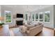Cozy living room with fireplace and large windows offering natural light at 1484 Old Rosebud Trl, Awendaw, SC 29429
