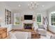 Bright living room features a fireplace, built-in shelving, and hardwood floors at 1484 Old Rosebud Trl, Awendaw, SC 29429