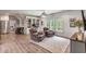 Relaxing recreation room with leather chairs, built-in shelves, and hardwood floors at 1484 Old Rosebud Trl, Awendaw, SC 29429