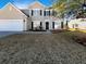 Two-story house with beige siding, white garage door, and landscaped yard at 158 Mayfield Dr, Goose Creek, SC 29445