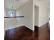 Bright hallway with dark hardwood floors and white railings at 158 Mayfield Dr, Goose Creek, SC 29445