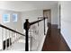Upstairs hallway with wood flooring and railing at 158 Mayfield Dr, Goose Creek, SC 29445
