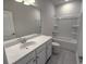 Clean bathroom with white vanity, bathtub, and tile floor at 1999 Central Ave, Summerville, SC 29483