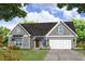 Gray farmhouse exterior with a two-car garage and landscaped front yard at 1999 Central Ave, Summerville, SC 29483