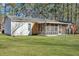 House back view with screened porch and green lawn at 209 Fenwick Rd, Walterboro, SC 29488