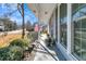 Covered porch with white railings and American flag at 211 Brailsford Rd, Summerville, SC 29485