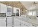 White kitchen with double sink, electric stove and ample cabinetry at 211 Brailsford Rd, Summerville, SC 29485