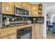 Kitchen boasts wood cabinets, black appliances and granite countertops at 211 Brailsford Rd, Summerville, SC 29485