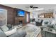 Spacious living area with wood feature wall, comfy sofas, and a large TV at 211 Brailsford Rd, Summerville, SC 29485